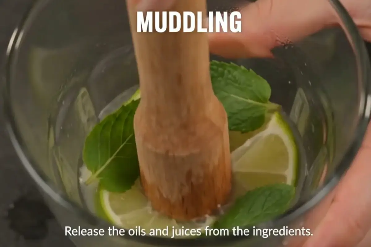 Gently muddle to release mint oils and lime juice.