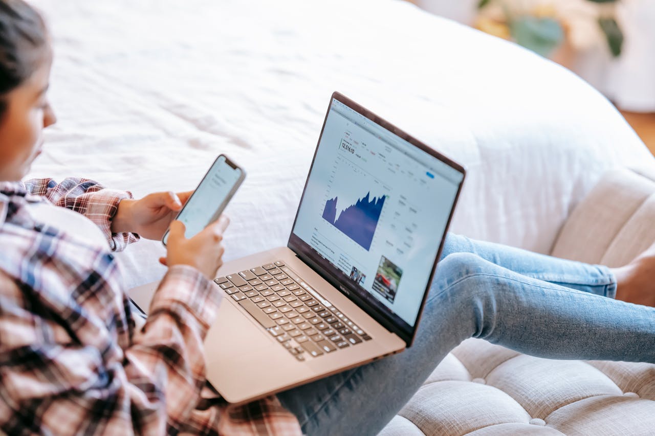 Person reviewing stock charts on a laptop, representing the process of online investing and trading.