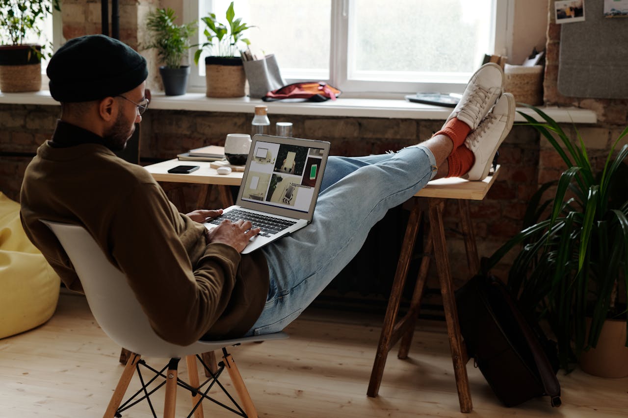 Person working on a laptop at a home office, representing the various methods of making money online from home.