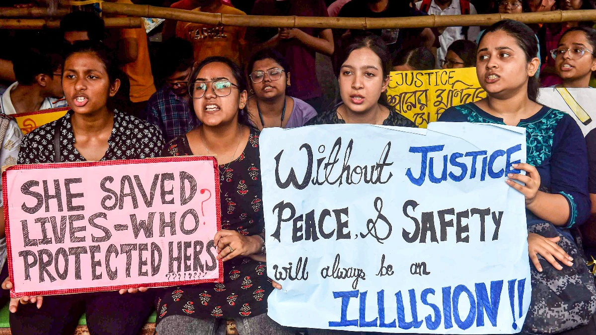 Crowds protesting with banners demanding justice for Abhigyan Chakraborty.