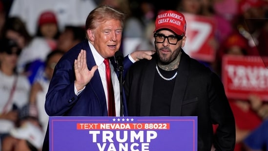 Republican presidential nominee former President Donald Trump, left, greets Nicky Jam during a campaign event at the World Market Center, Friday, Sept.13, 2024, in Las Vegas. (AP)