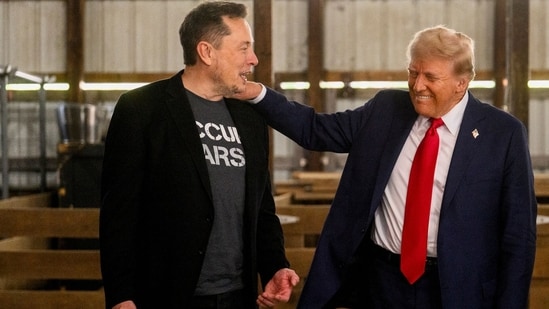 Elon Musk, chief executive officer of Tesla Inc., left, and former US President Donald Trump, prior to a campaign event at the Butler Farm Show in Butler, Pennsylvania, US.(Bloomberg)