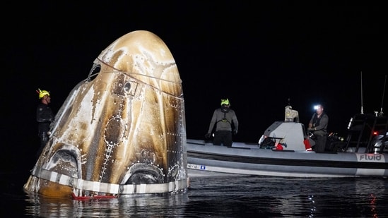 In this NASA handout, Support teams work around the SpaceX Dragon Endeavour spacecraft shortly after it landed with NASA astronauts Matthew Dominick, Michael Barratt, and Jeanette Epps, and Roscosmos cosmonaut Alexander Grebenkin aboard in the Gulf of Mexico off the coast of Pensacola, Florida on October 25, 2024.(Getty Images via AFP)