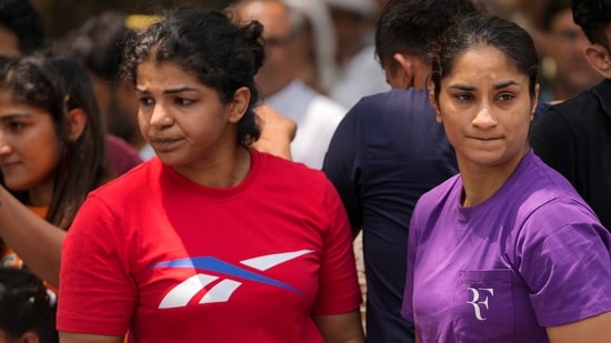 Wrestlers Vinesh Phogat and Sakshi Malik with supporters during their protest against Wrestling Federation of India (WFI) chief Brij Bhushan Sharan Singh.(PTI)