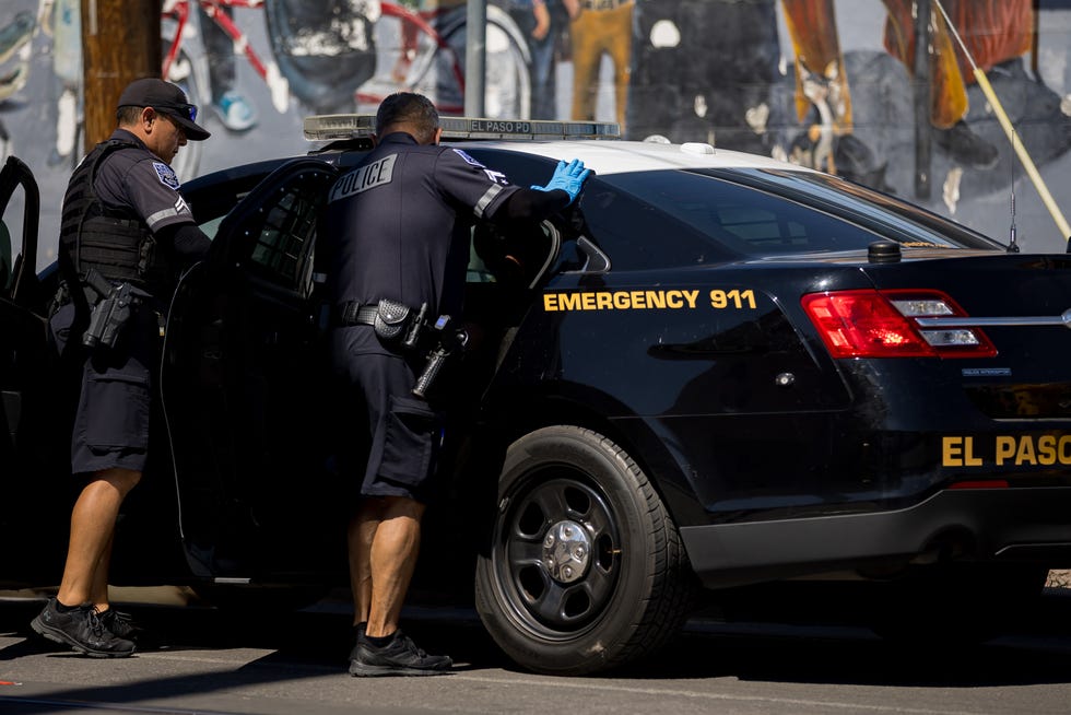 El Paso Police check take Emerson Linares, a Venezuelan migrant, after checking his tattoos from the street across Sacred Heart Church on Tuesday, Sept. 24, 2024, where migrants are staying.