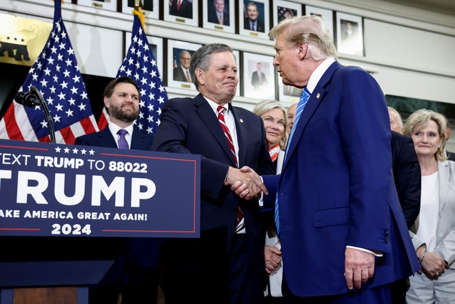 WASHINGTON, DC - JUNE 13: Republican presidential candidate, former U.S. President Donald Trump shakes hands with Sen. Steve Daines (R-MT) at the National Republican Senatorial Committee building on June 13, 2024 in Washington, DC. Trump is visiting Capitol Hill to meet with Senate Republicans and participate in additional meetings.