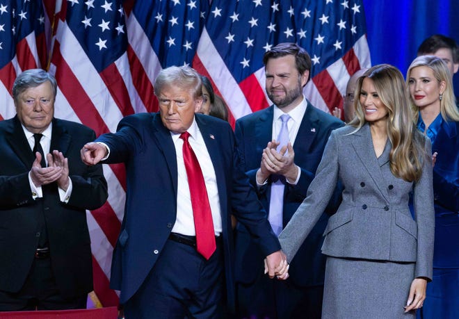 Donald Trump holds hands with wife Melania at his Election Night Watch Party at the Palm Beach County Convention Center after being elected the 47th President of the United States.