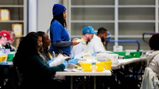 Election workers flatten ballots at the Philadelphia City Commissions Office & Elections Warehouse in Philadelphia, Pennsylvania, US, on Tuesday, Nov. 5, 2024. The 2024 presidential campaign was marked by two assassination attempts, a candidate switch, divisive rhetoric and warnings about the fate of democracy. Photographer: Hannah Beier/Bloomberg(Bloomberg)