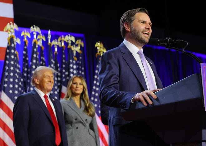 Republican vice presidential nominee JD Vance speaks as Republican presidential nominee and former U.S. President Donald Trump and his wife Melania watch as he addresses supporters at Trump's rally, at the Palm Beach County Convention Center in West Palm Beach, Florida, U.S., November 6, 2024.