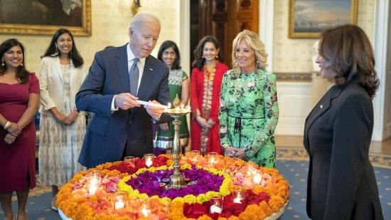 US President Joe Biden lights a lamp as First Lady Jill Biden and Vice-President Kamala Harris look on during an event to celebrate Diwali at the White House in Washington on Monday. (PTI)