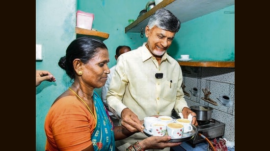 Andhra Pradesh chief minister N Chandrababu Naidu serves tea at the home of a beneficiary during the launch of ‘Deepam-2’, at Eedupuram village in Srikakulam district on Friday. (PTI)