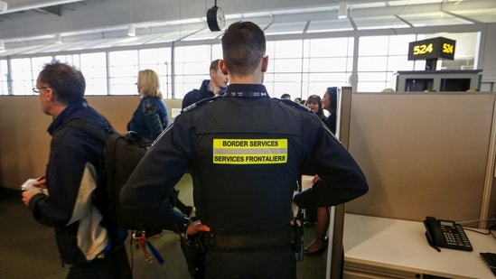 Canada Border Services Agency (CBSA) officer watches during a tour of the Infield Terminal, at Toronto Pearson International Airport.(REUTERS)