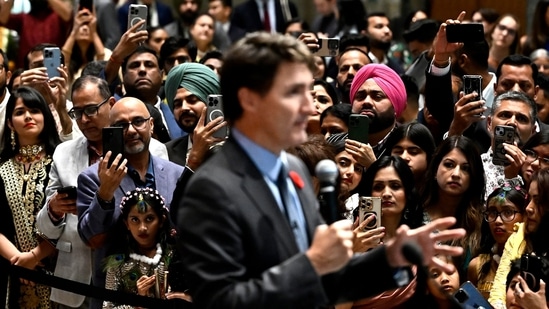 Attendees use their phones to record Canadian Prime Minister Justin Trudeau as he delivers remarks at the Diwali and Bandi Chhor Divas on the Hill celebration in Ottawa, Ontario, ob Monday, (AP)