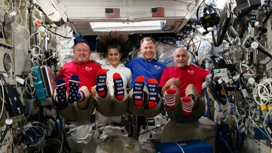 In this photo provided by NASA, from left, astronauts Butch Wilmore, Suni Williams, Nick Hague and Don Pettit show their U.S. flag-themed socks aboard the International Space Station on Election Day, Tuesday, Nov. 5, 2024. (AP)