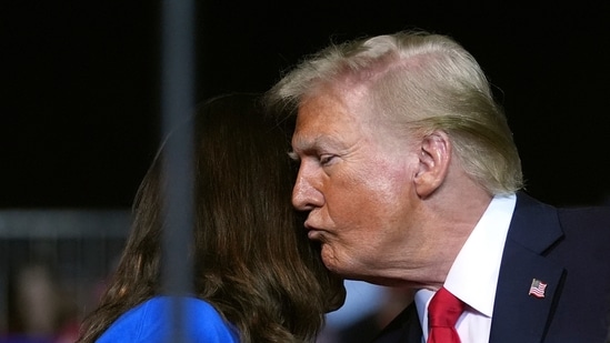 Republican presidential nominee former President Donald Trump kisses a family member as Tammy Nobles, mother of Kayla Hamilton, finishes speaking at a campaign rally at the Salem Civic Center, Saturday, Nov. 2, 2024, in Salem, Va. (AP Photo/Evan Vucci)(AP)