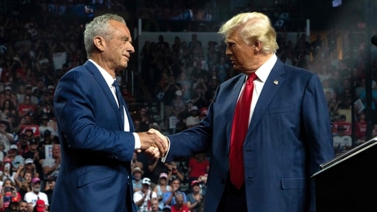 Former Republican presidential candidate Robert F. Kennedy Jr. and former US President and Republican presidential candidate Donald Trump shake hands during a campaign rally at Desert Diamond Arena on August 23, 2024 in Glendale, Arizona. (AFP)