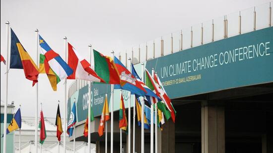 Flags fly near a venue of the COP29 United Nations climate change conference, in Baku, Azerbaijan, on Wednesday. (REUTERS)