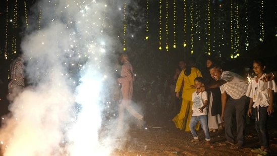 People light fire crackers during Diwali, the festival of lights (AP Photo/Rafiq Maqbool)(AP)