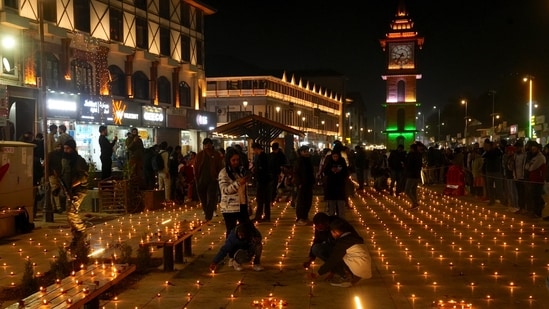 People light 'diyas' during the Diwali festival celebrations at Lal Chowk, in Srinagar, Thursday night.(PTI)