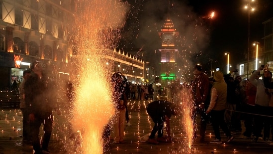 People burst firecrackers during the Diwali festival celebrations at Lal Chowk, in Srinagar on Thursday.(PTI)