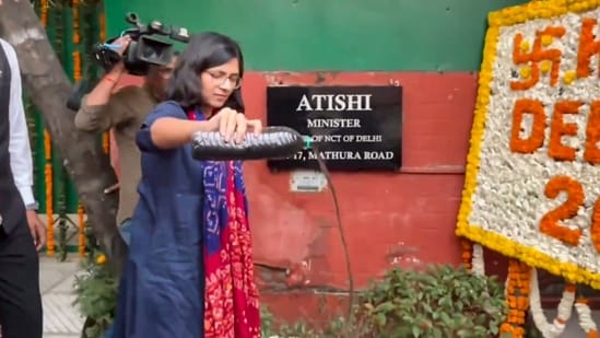 Rajya Sabha MP Swati Maliwal pours dirty water, allegedly brought from the house of an army officer in Dwarka, outside Delhi Chief Minister Atishi's residence, in New Delhi.(PTI)