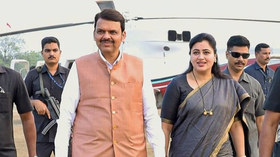 Maharashtra deputy chief minister Devendra Fadnavis with BJP leader Navneet Rana during an election rally ahead.(PTI file photo)