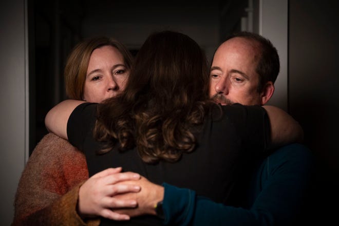 Samantha and Brian Williams embrace their daughter, L, for a portrait at their home in Nashville, Tenn., on Wednesday, Nov. 13, 2024.