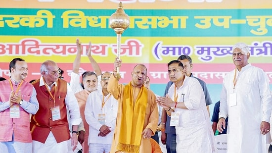 Uttar Pradesh chief minister Yogi Adityanath holds a mace during a public meeting for the Kundarki Assembly Constituency by-election, in Moradabad on Friday. (Yogi Adityanath-X/ANI Photo)