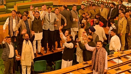 Bharatiya Janata Party (BJP) members shout slogans against the resolution passed by Jammu and Kashmir assembly seeking the restoration of special status. (AFP)