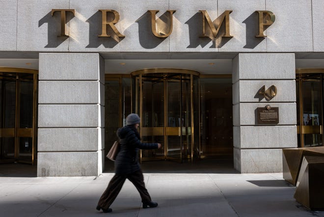 People walk by 40 Wall Street, a Trump-owned building in downtown Manhattan on March 19, 2024 in New York City. Trump was fined $354.8 million plus approximately $100 million in pre-judgment interest after Judge Arthur Engoron determined that he inflated his net worth in order to receive more favorable loan terms.