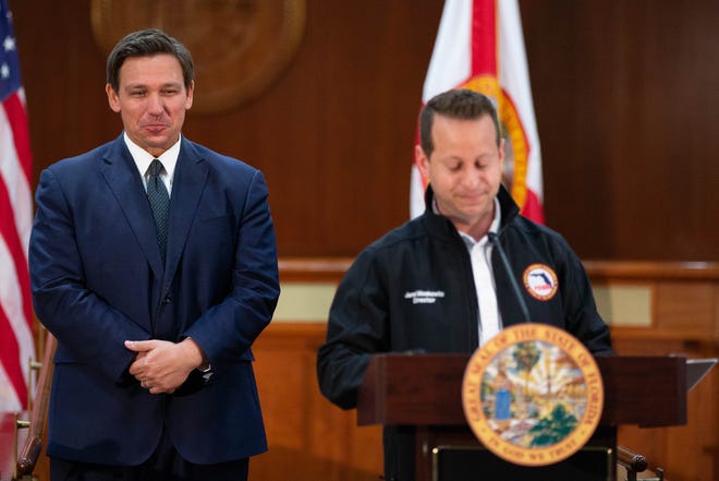 Gov. Ron DeSantis holds back laughter as Florida Department of Emergency Management Director Jared Moskowitz speaks during a press conference where DeSantis gave a PowerPoint presentation titled "Facts vs. Smears," "debunking" the 60 Minutes story about him and vaccine distribution at the Capitol Wednesday, April 7, 2021.

Desantis 60 Minutes Presser 040721 Ts 002