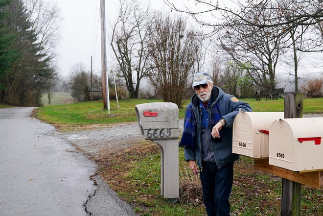 Chuck Klein stands next to the cluster of mailboxes where he now picks up his mail. The U.S. Postal Service moved his box here after concluding it was unsafe to deliver closer to his home.