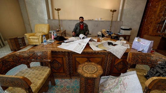 After rebel forces officially secured the capital city of Damascus, people celebrated the fall of dictator and president Bashar al-Assad's regime of 24 years. A Syrian opposition fighter is seen here sitting inside an office at the presidential palace after the ouster.(AP)