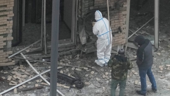 Investigators work near a scooter at the place where Lt. General Igor Kirillov, the head of Russia's Nuclear, Biological, and Chemical Defence Forces and his assistant Ilya Polikarpov were killed by an explosive device planted close to a residential apartment's block in Moscow, Russia, Tuesday, Dec. 17, 2024.(AP)