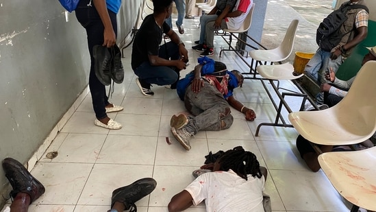 Journalists lie wounded after being shot by armed gangs at the general hospital in Port-au-Prince, Haiti, on Tuesday.(AP)