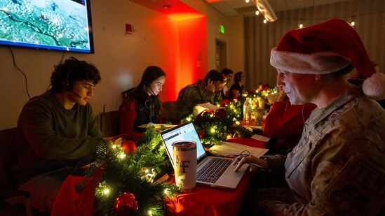 Air Force Col. Amy Glisson and other volunteers answer phone calls from around the world Tuesday, Dec. 24, 2024, at the NORAD Tracks Santa center at Peterson Space Force Base in Colorado Springs, Colo. (AP)