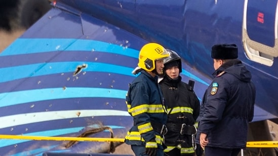 Emergency specialists work at the crash site of an Azerbaijan Airlines passenger jet near the western Kazakh city of Aktau on December 25, 2024. (AFP)