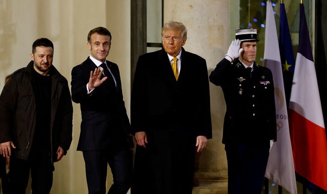 French President Emmanuel Macron accompanies U.S. President-elect Donald Trump and Ukraine's President Volodymyr Zelenskyy after a trilateral meeting at the Elysee Palace in Paris as part of ceremonies to mark the reopening of the Notre-Dame de Paris Cathedral, five-and-a-half years after a fire ravaged the Gothic masterpiece, France, December 7, 2024.