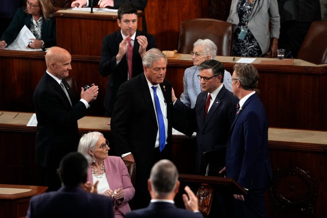 Rep. Mike Johnson, R-La., second from left, stands with Rep. Keith Self, R-Texas, left and Rep. Ralph Norman, R-S.C., second from left, in the House Chamber after Self and Norman changed their votes to elect Johnson as the new Speaker of the House during the first session of the 119th Congress at the US Capitol in Washington, DC, on Jan. 3, 2025.