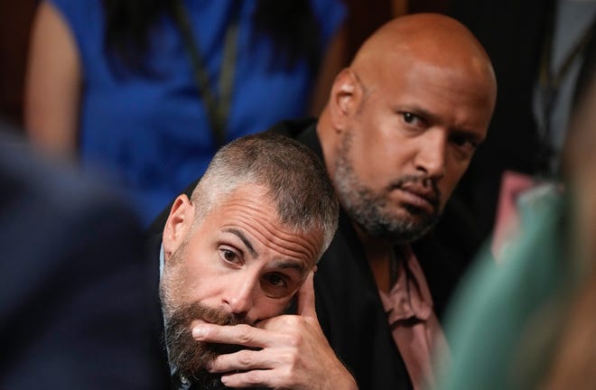 Jul 21, 2022; Washington DC, United States; Former DC Metro Police officers Michael Fanone (left) and Harry Dunn listen to testimony during a public hearing before the House select committee to investigate the January 6 attack on the United States Capitol held on July 21, 2022. Mandatory Credit: Jack Gruber-USA TODAY