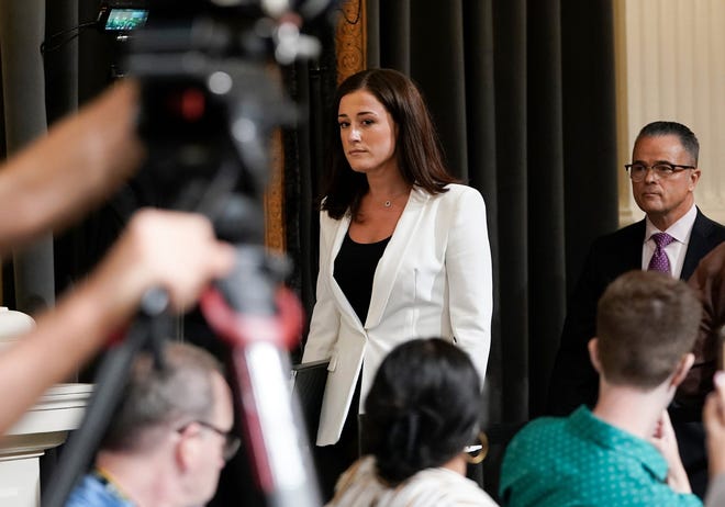 Cassidy Hutchinson, aide to former White House chief of staff Mark Meadows, walks to the witness table before testifying at the House select committee investigating the Jan. 6 attack on the U.S. Capitol.