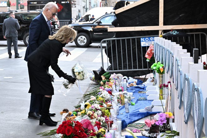 President Joe Biden and First Lady Jill Biden lay flowers as they pay their respects to victims of the January 1 truck attack at a makeshift memorial in Bourbon Street in New Orleans, Louisiana, on January 6, 2025.